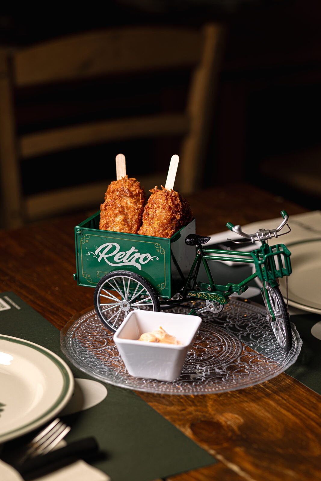 Frittura di gambas servida en triciclo vintage Retro sobre vajilla de greca verde
