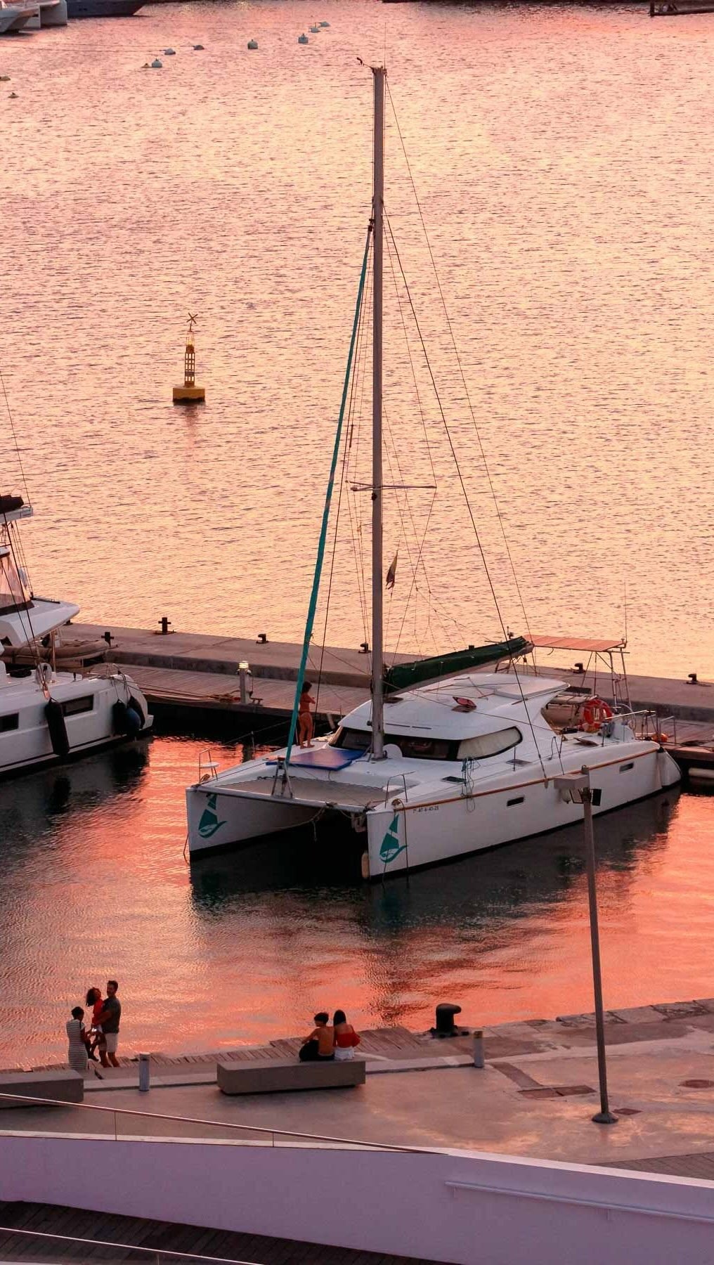 Catamarán amarrado en la Marina de València al atardecer, vista desde la terraza ÁTICO
